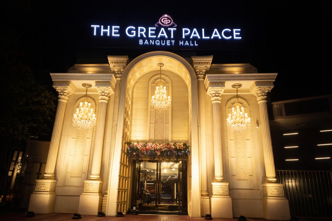 The Great Palace Banquet Hall — Grand illuminated exterior at night with crystal chandeliers and branding, Seelampur East Delhi